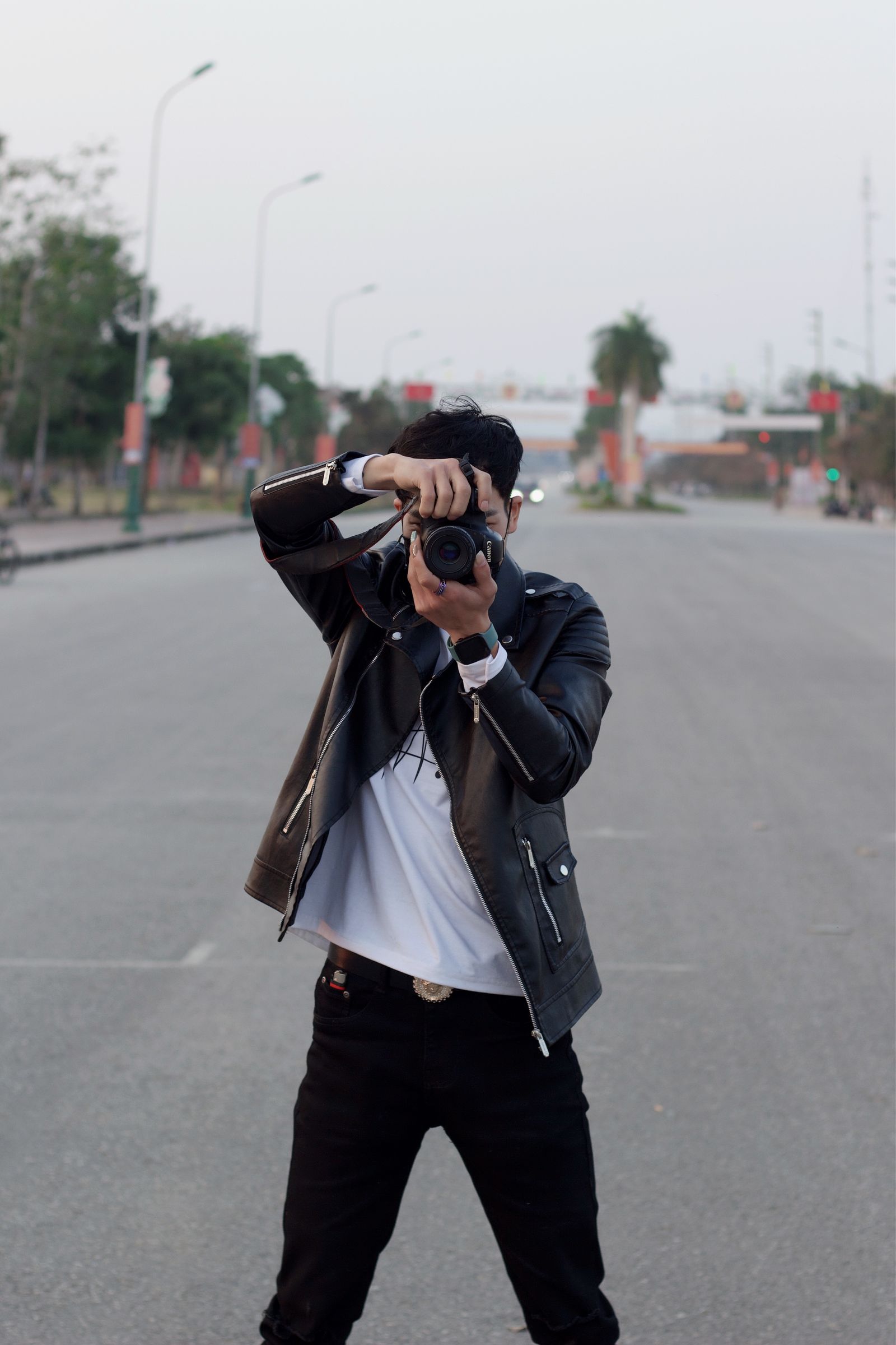 Man in leather jacket taking photos