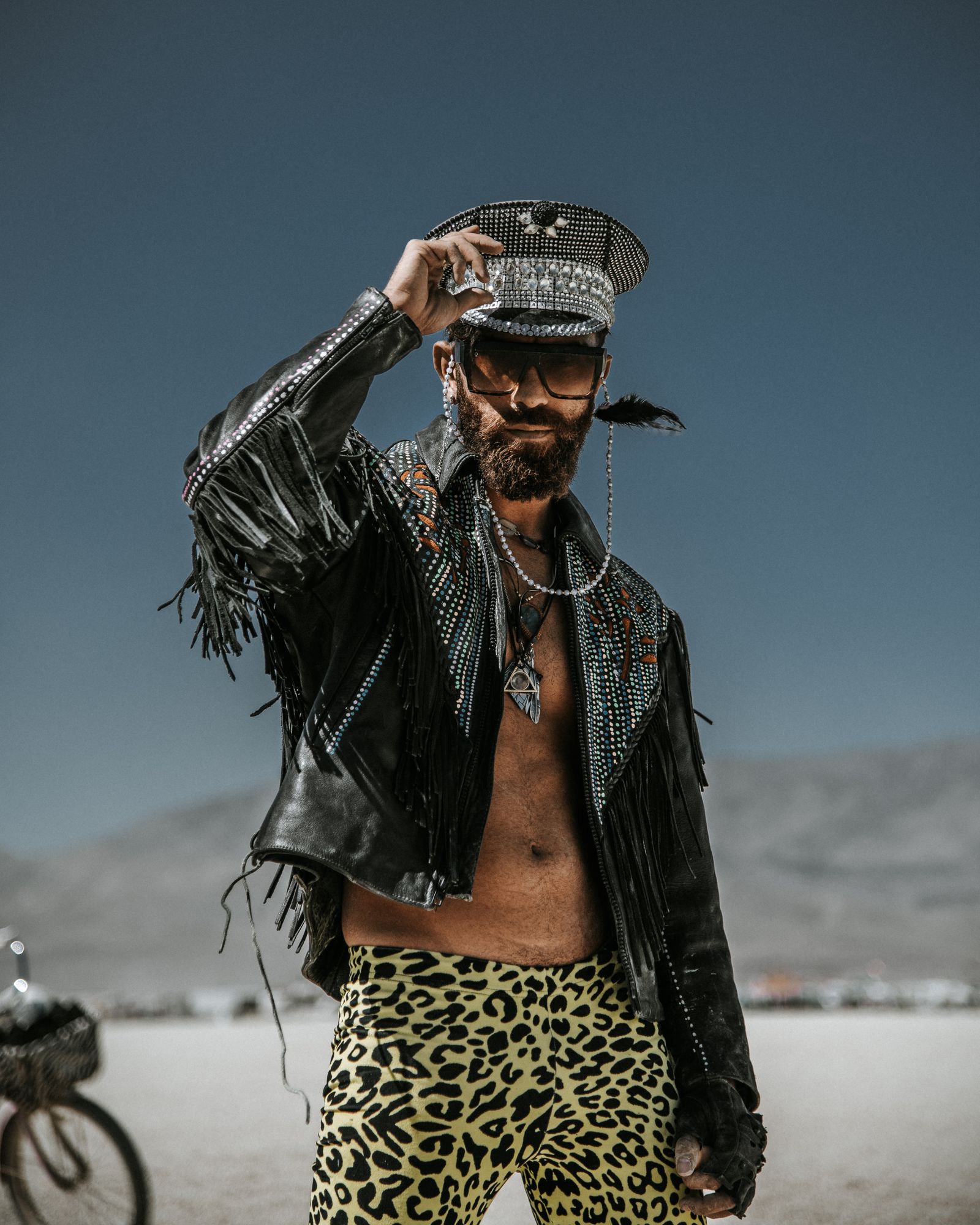 Man wearing black leather jacket in desert