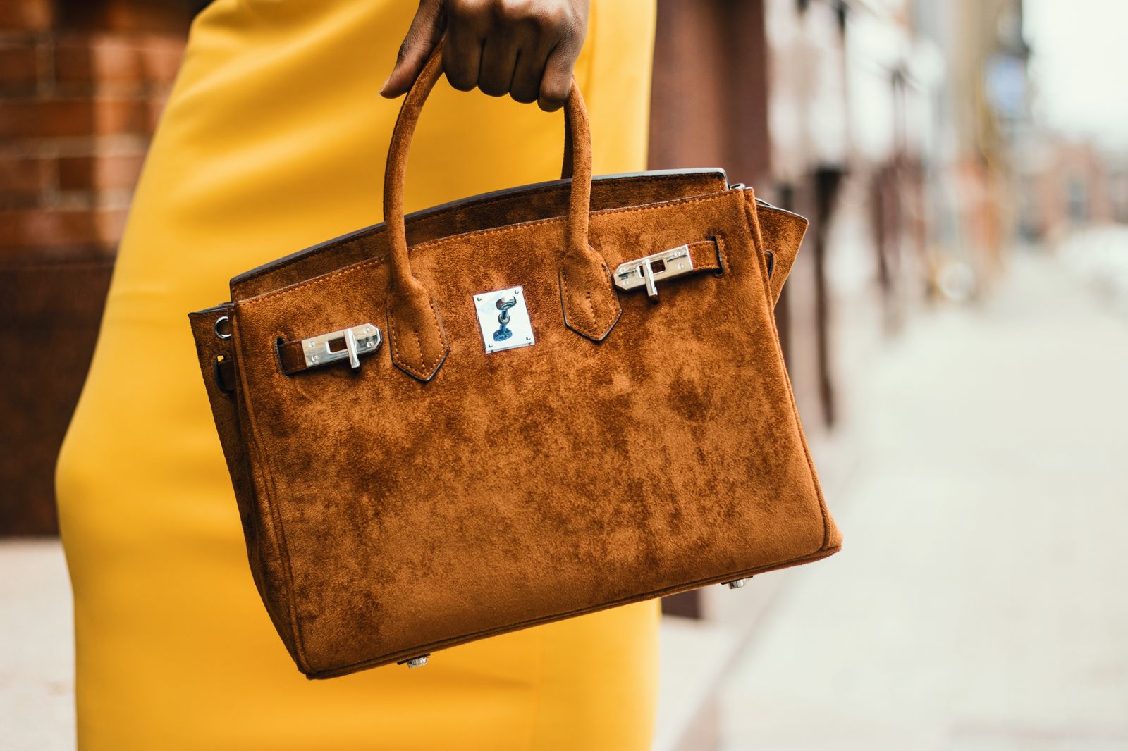Woman wearing brown leather tote bag