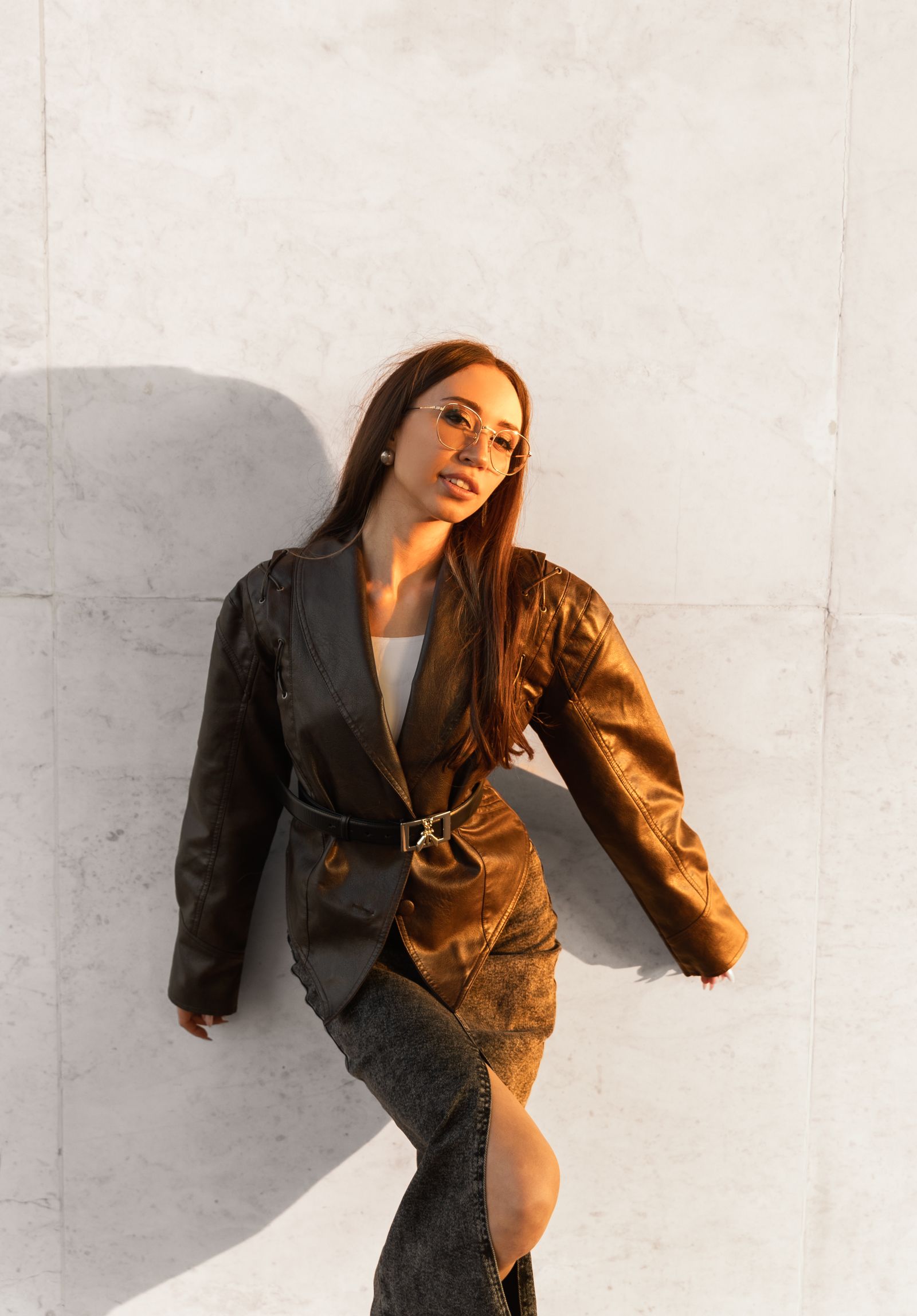 Stylish woman in leather jacket outdoors